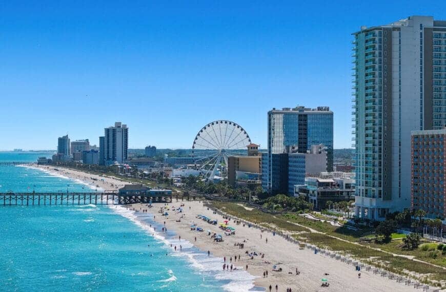 myrtle beach travel guide A view of a beach with a ferris wheel in the distance