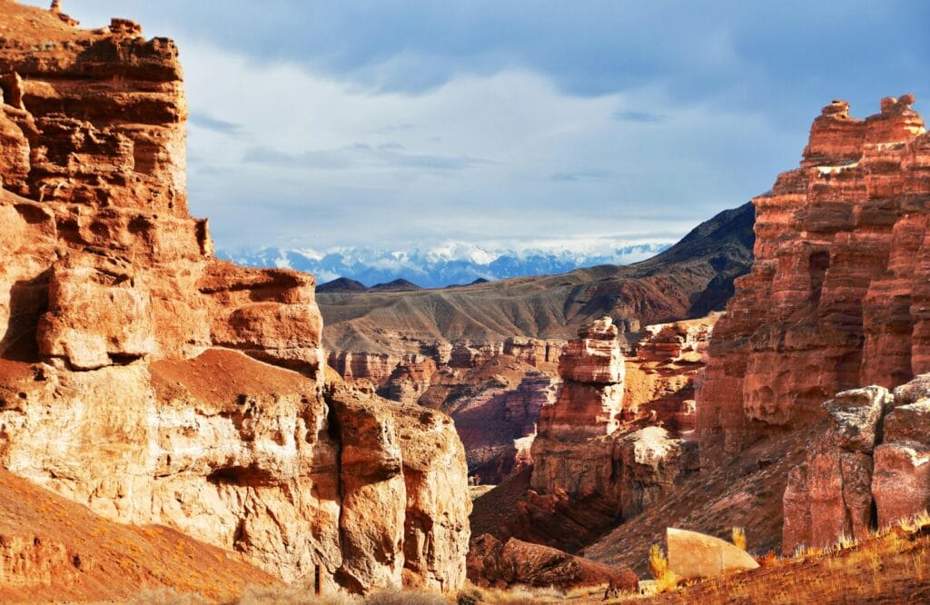 Kazakhstan Travel Guide a rocky landscape with mountains in the background