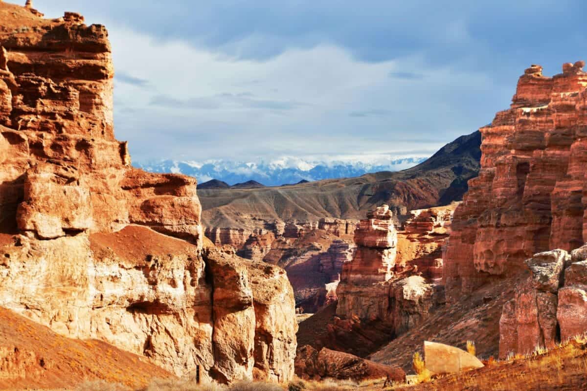 Kazakhstan Travel Guide a rocky landscape with mountains in the background