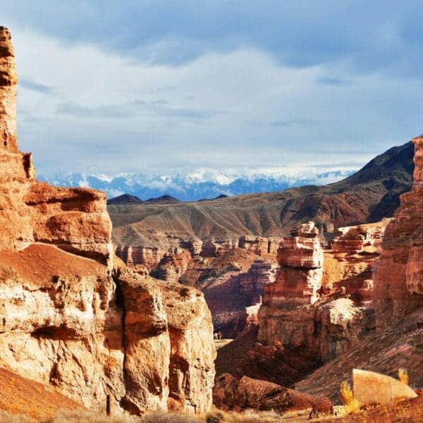 Kazakhstan Travel Guide a rocky landscape with mountains in the background