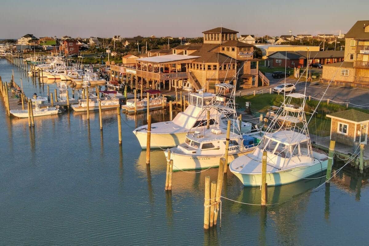 North Carolina Travel Guide white and blue boats on dock during daytime