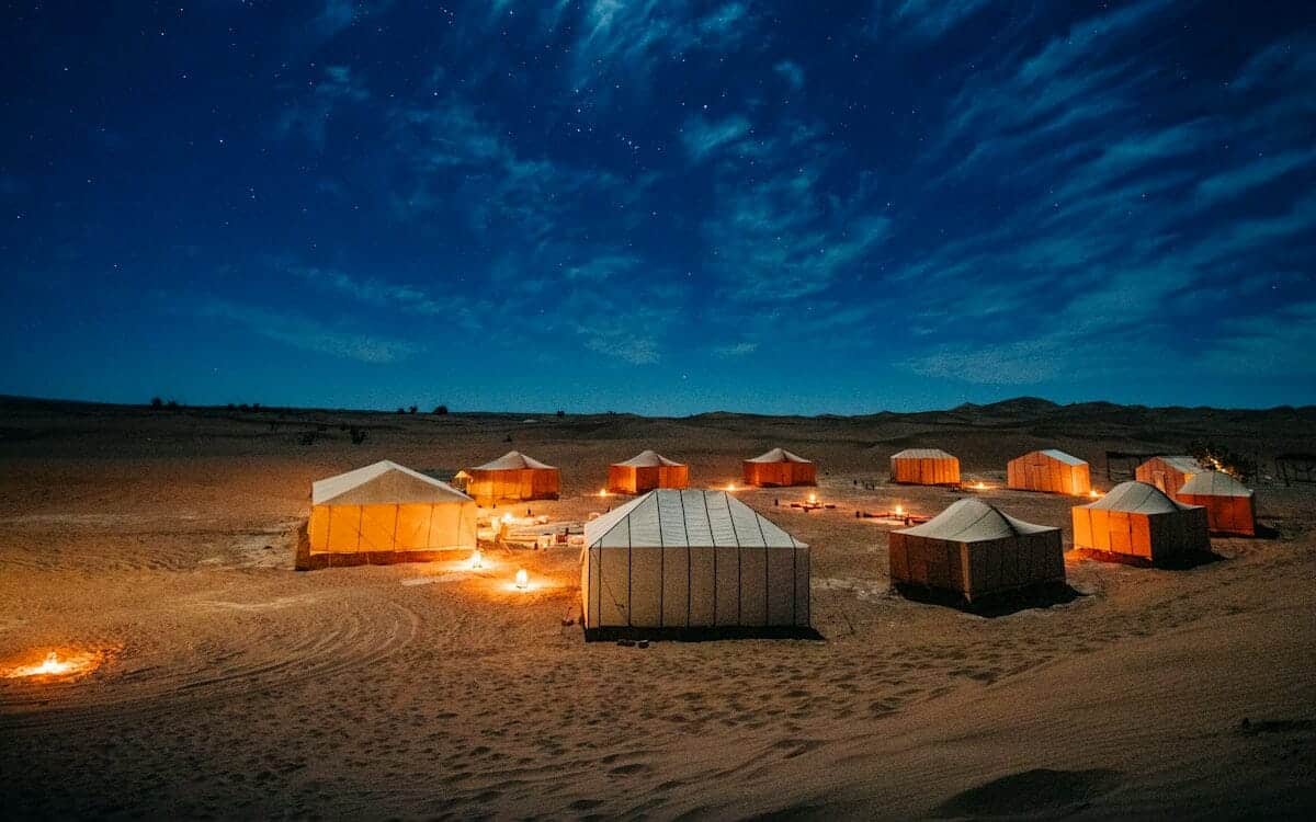 morocco travel guide white and brown tent on brown field under blue sky during night time