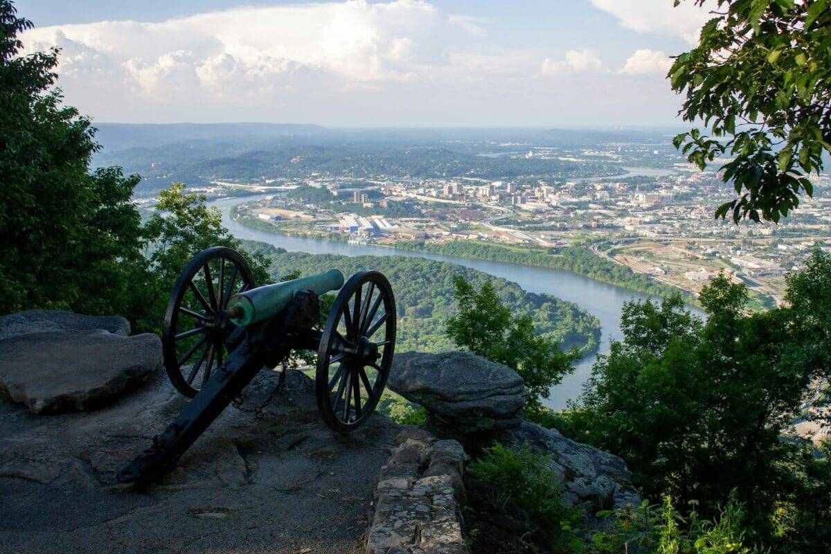 Tennessee Travel Guide black metal wheel on gray rock near body of water during daytime