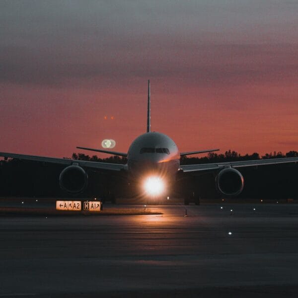 onetravel deals A large jetliner sitting on top of an airport tarmac