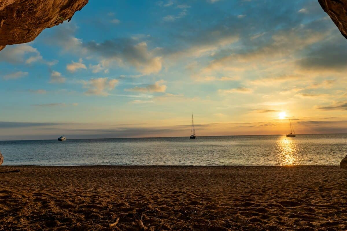 Sardinia Tours the sun is setting in a cave on the beach
