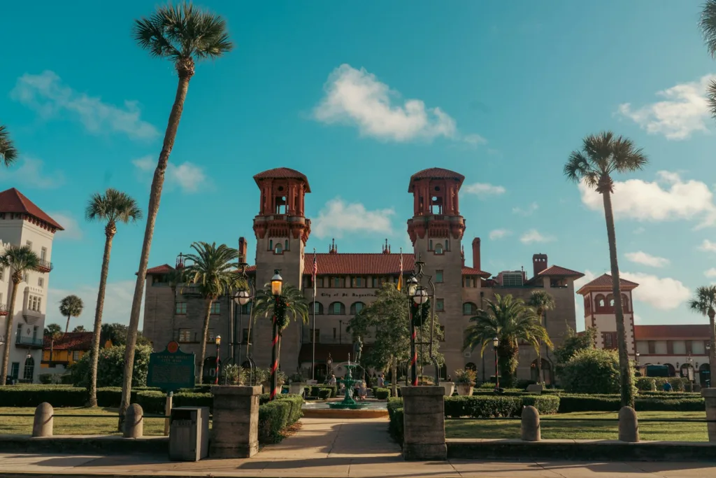 St Augustine Travel Guide a large building surrounded by palm trees on a sunny day