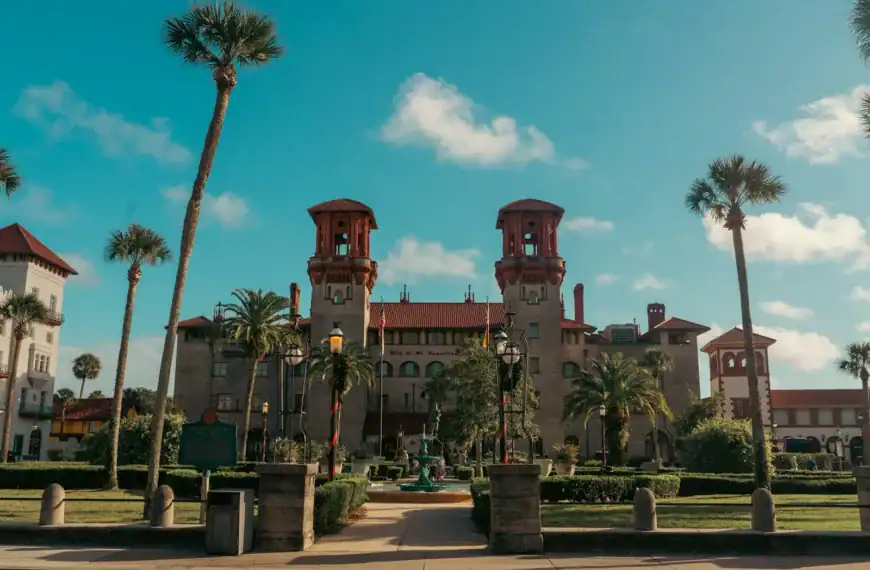 St Augustine Travel Guide a large building surrounded by palm trees on a sunny day