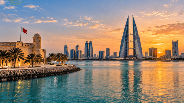 Bahrain waterfront at sunset with palm-lined historic architecture and Manama's modern skyline across the water.