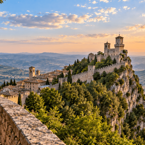 Medieval fortress towers rise above San Marino on Mount Titano, overlooking rolling countryside and distant mountains.