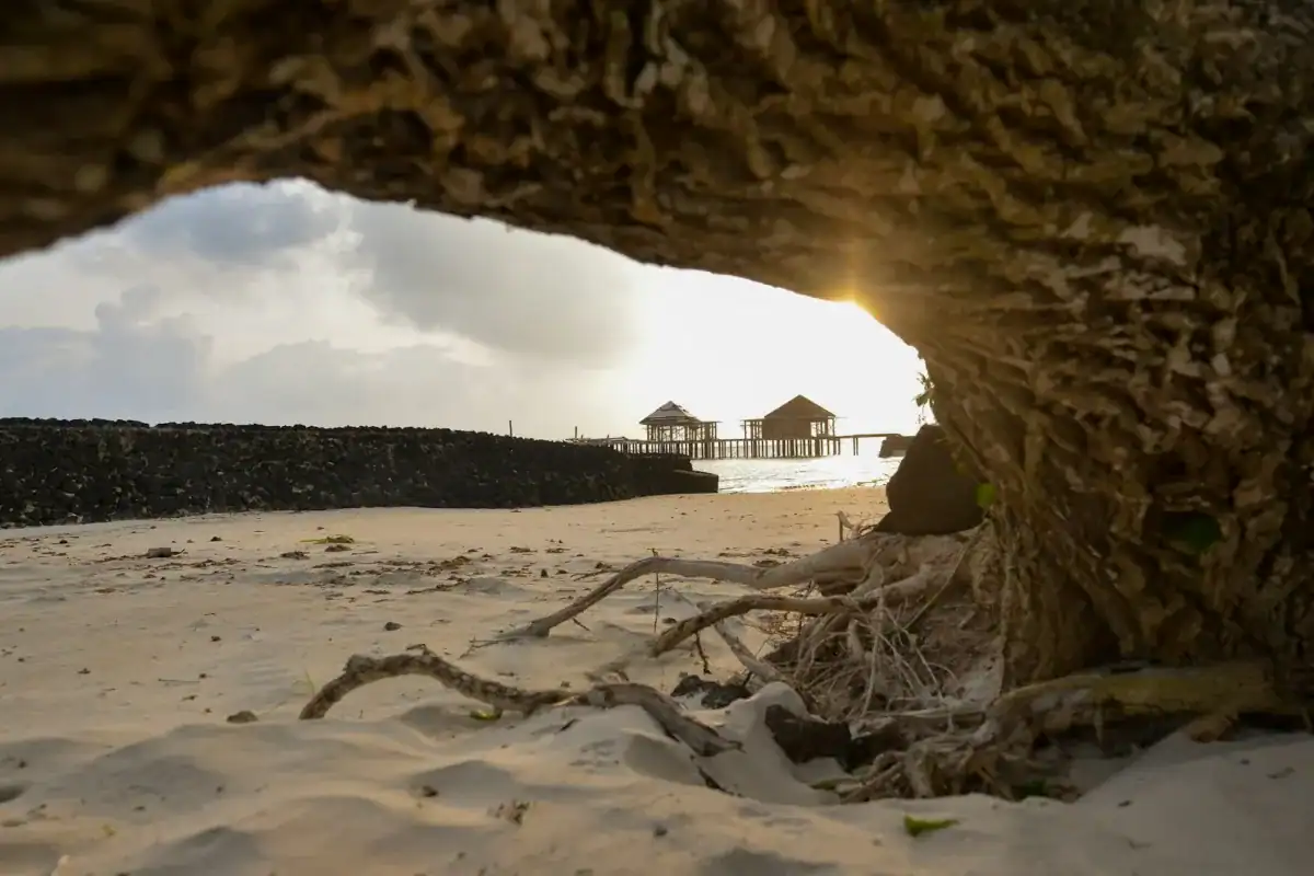 Samoa Travel Guide brown wooden house on white sand under white clouds during daytime