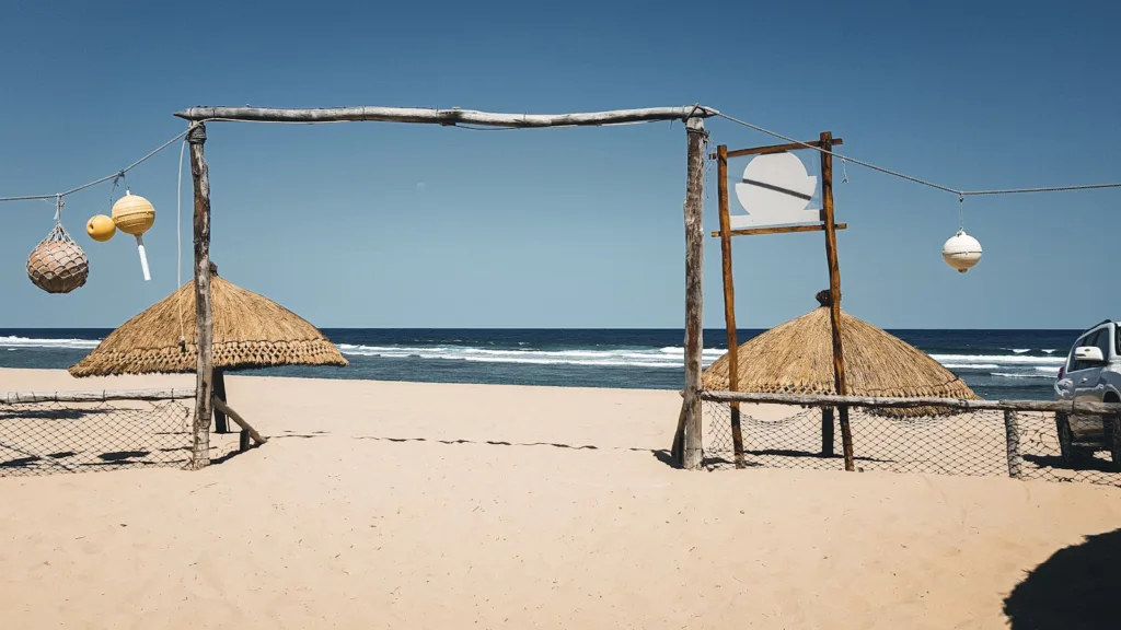 Mozambique Tours brown wooden beach house on white sand beach during daytime
