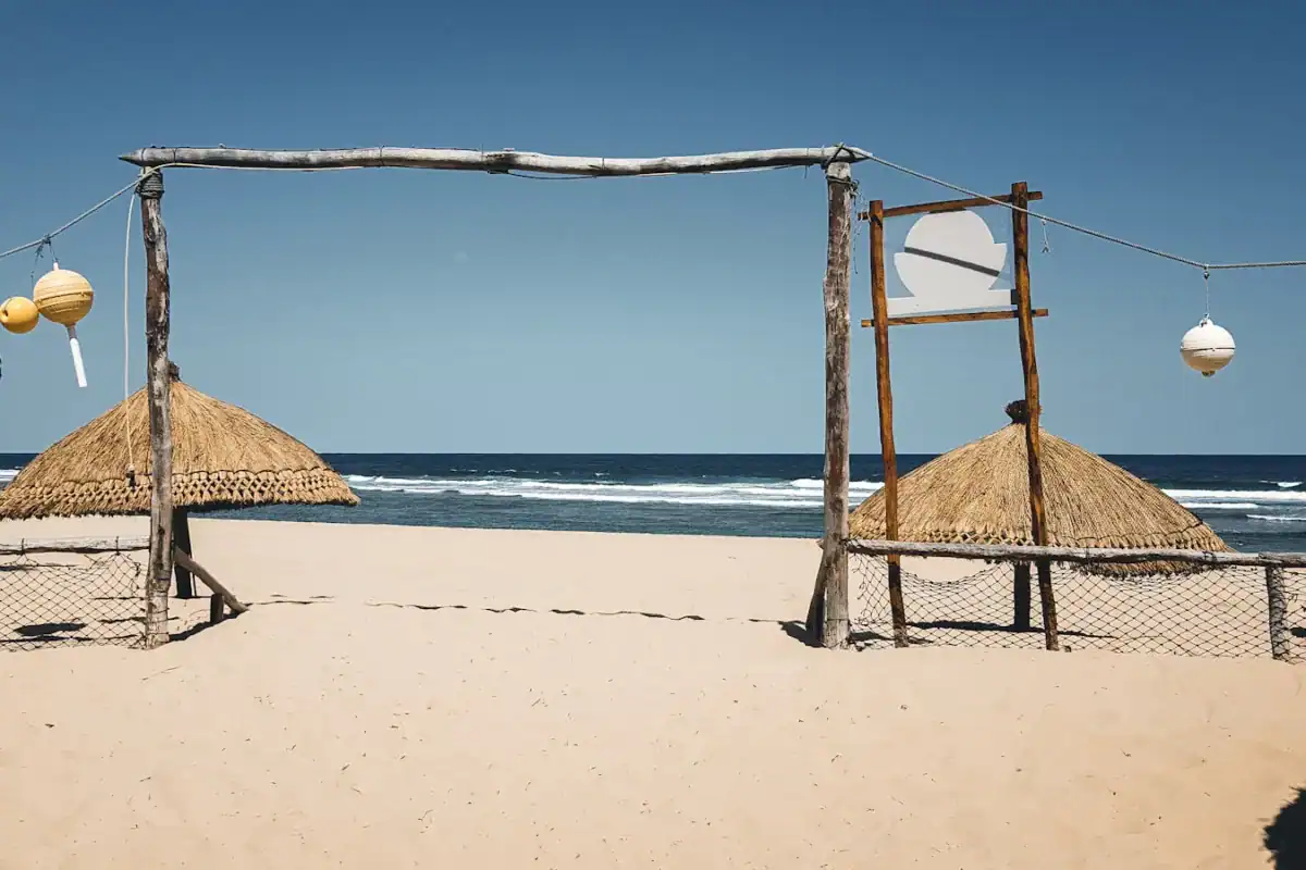 Mozambique Tours brown wooden beach house on white sand beach during daytime