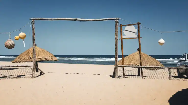 Mozambique Tours brown wooden beach house on white sand beach during daytime