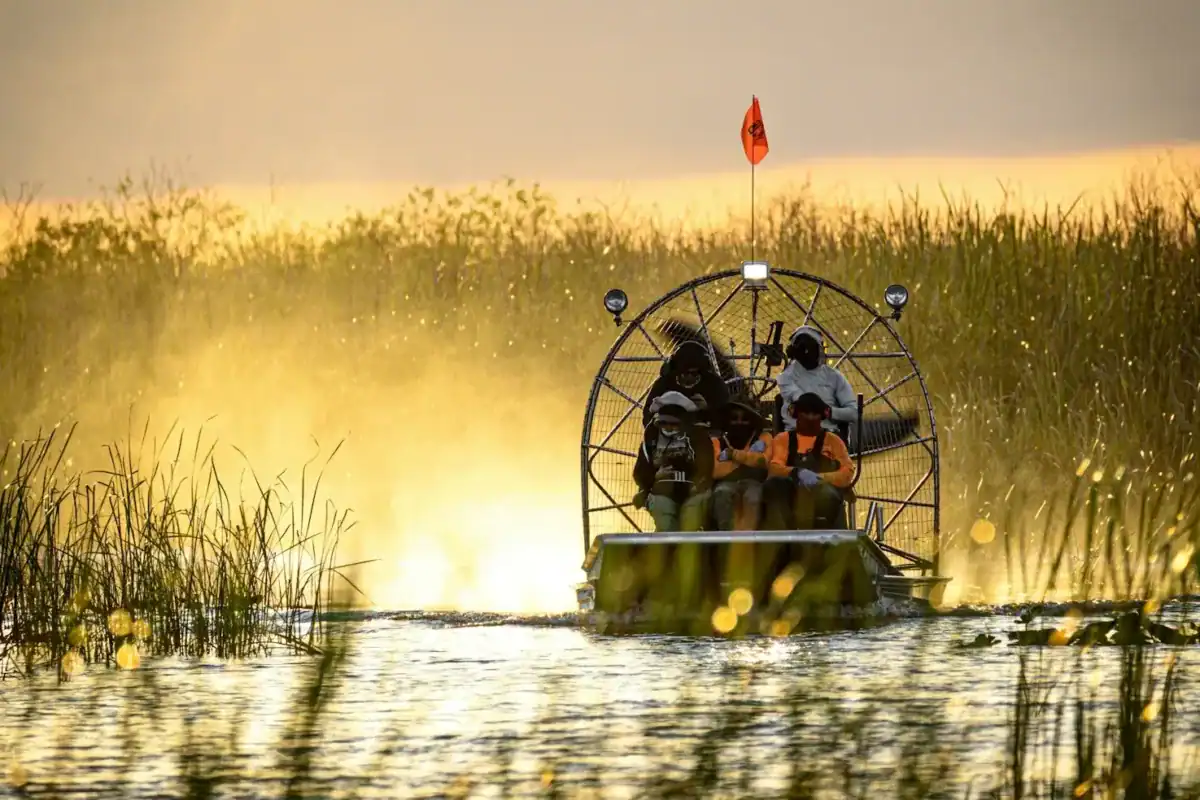 Everglades Travel Guide a couple of people on a boat in a body of water