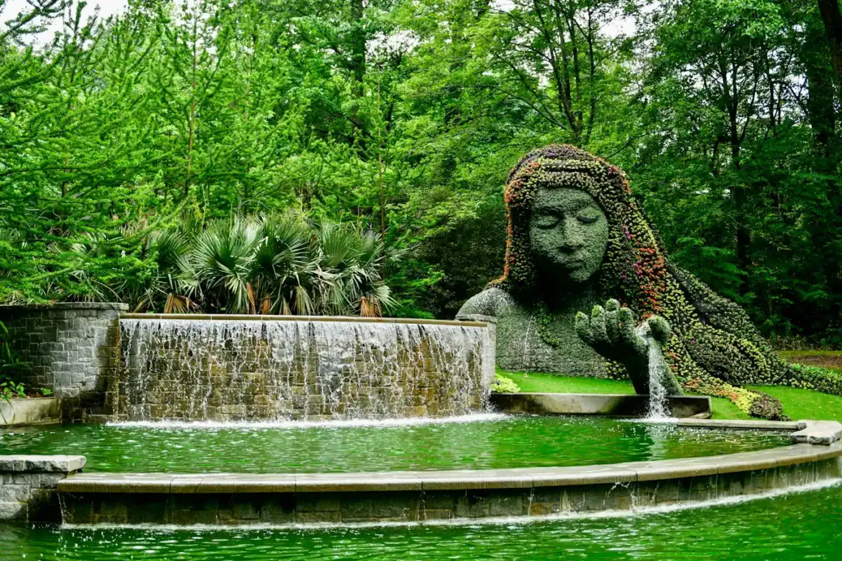Georgia USA Tours a statue of a woman is in the middle of a pond