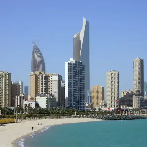 Kuwait Travel Guide people on beach near high rise buildings during daytime