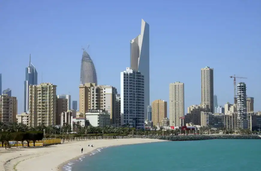 Kuwait Travel Guide people on beach near high rise buildings during daytime