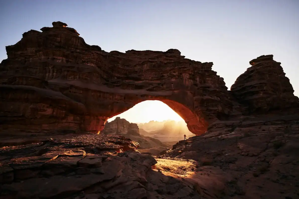 Saudi Arabia Travel Guide a large rock formation with a small hole in the middle of it