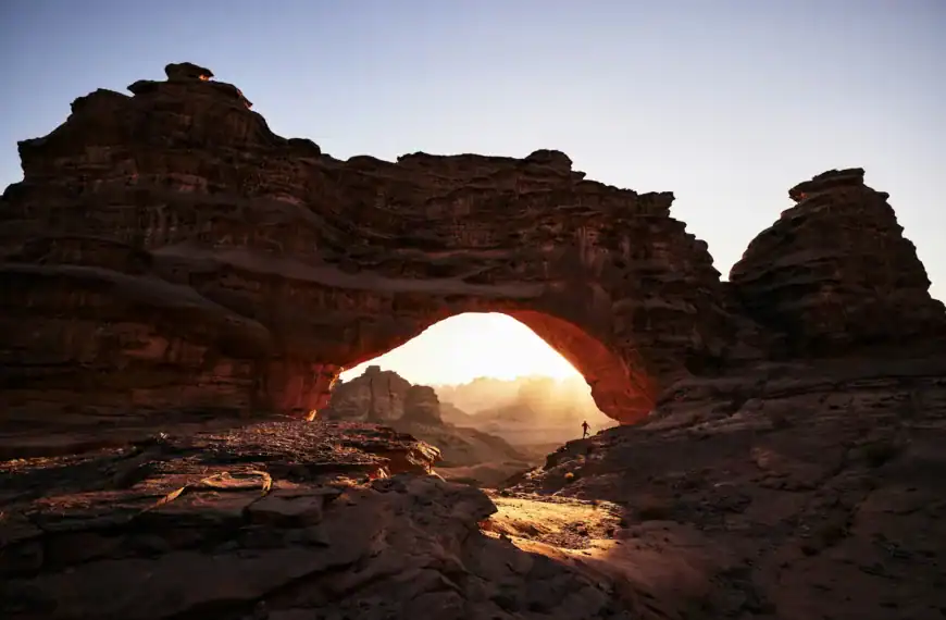 Saudi Arabia Travel Guide a large rock formation with a small hole in the middle of it