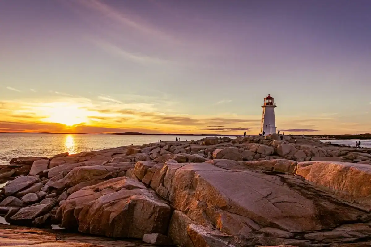 Nova Scotia Travel Guide a lighthouse sitting on top of a rocky shore