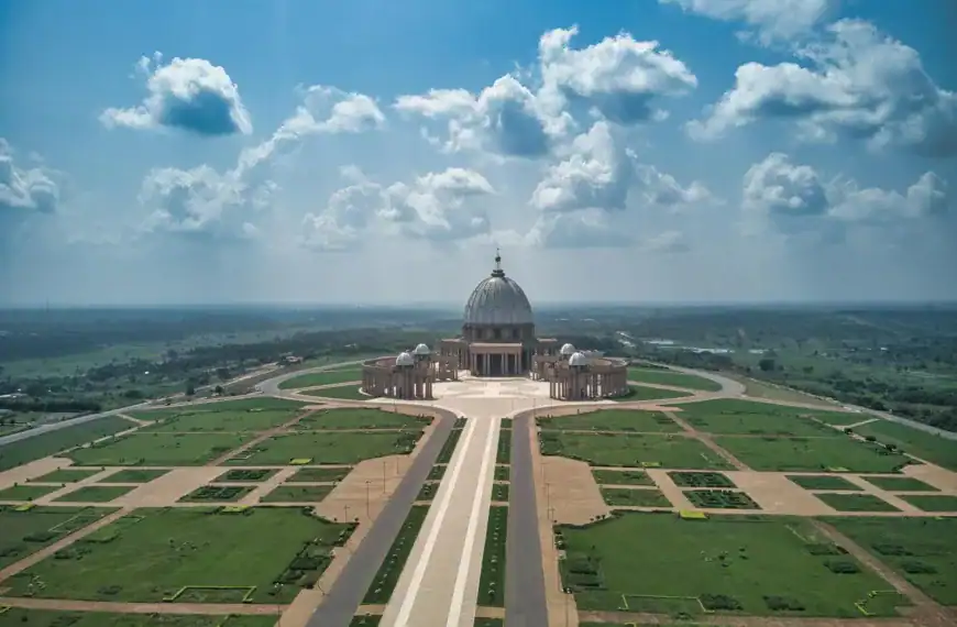 Côte d’Ivoire Travel Guide Aerial view of the Basilica of Our Lady of Peace in Yamoussoukro under a bright sky.