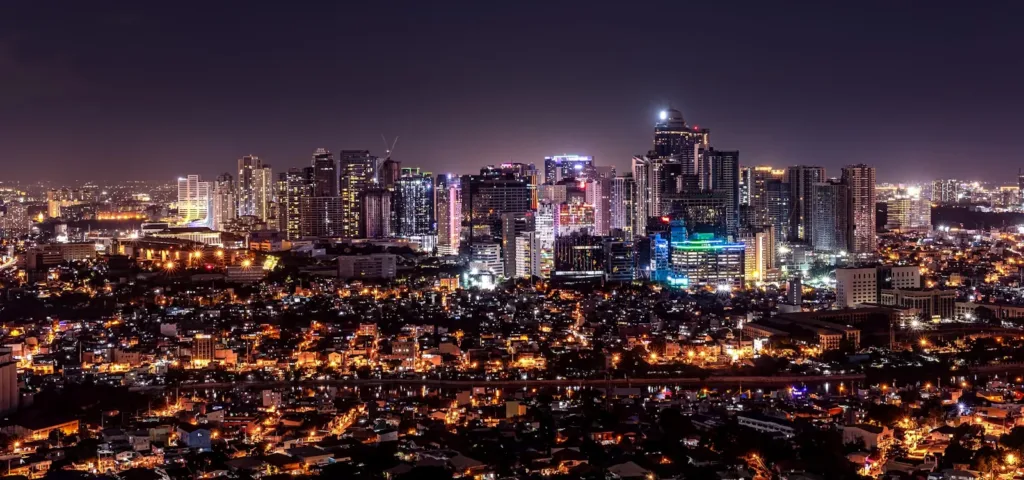 manila travel guide city with high rise buildings during night time