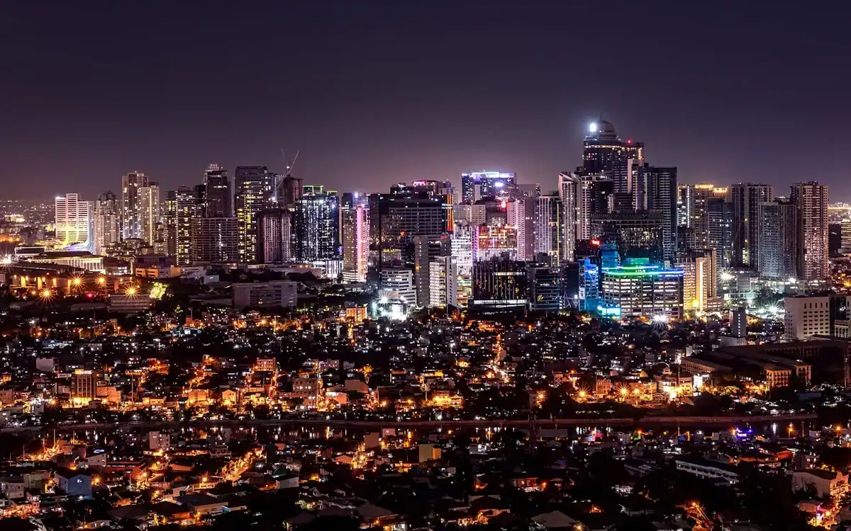 manila travel guide city with high rise buildings during night time