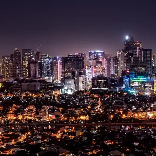 manila travel guide city with high rise buildings during night time