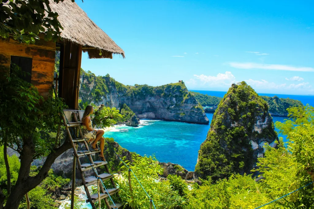 What Travel Guide brown wooden folding chairs on green grass field near body of water during daytime