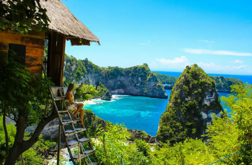 What Travel Guide brown wooden folding chairs on green grass field near body of water during daytime