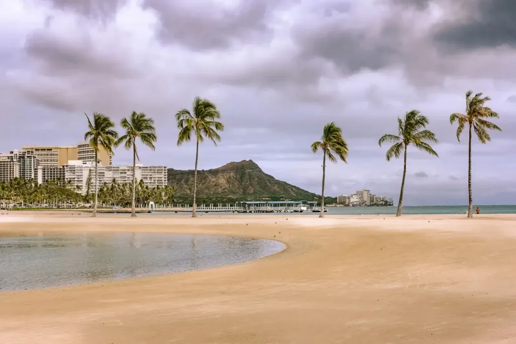 Honolulu Travel Guide people walking on beach during daytime