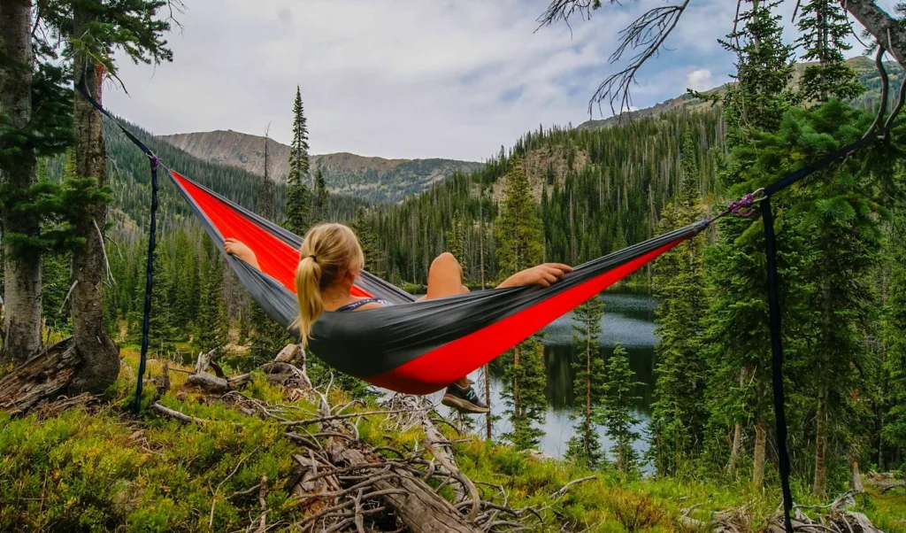 Travel Essentials Hub woman on hammock near to river