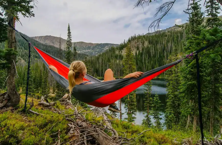 Travel Essentials Hub woman on hammock near to river