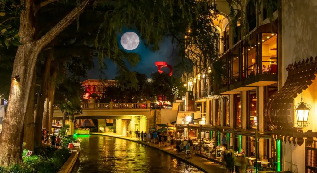 San Antonio Travel Guide a river running through a city at night