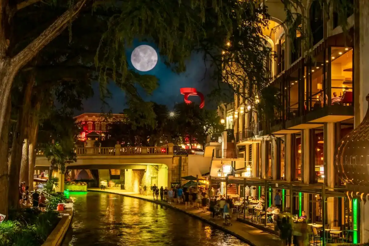 San Antonio Travel Guide a river running through a city at night