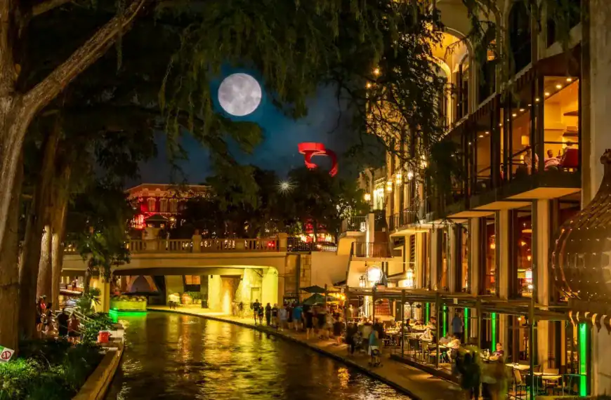 San Antonio Travel Guide a river running through a city at night