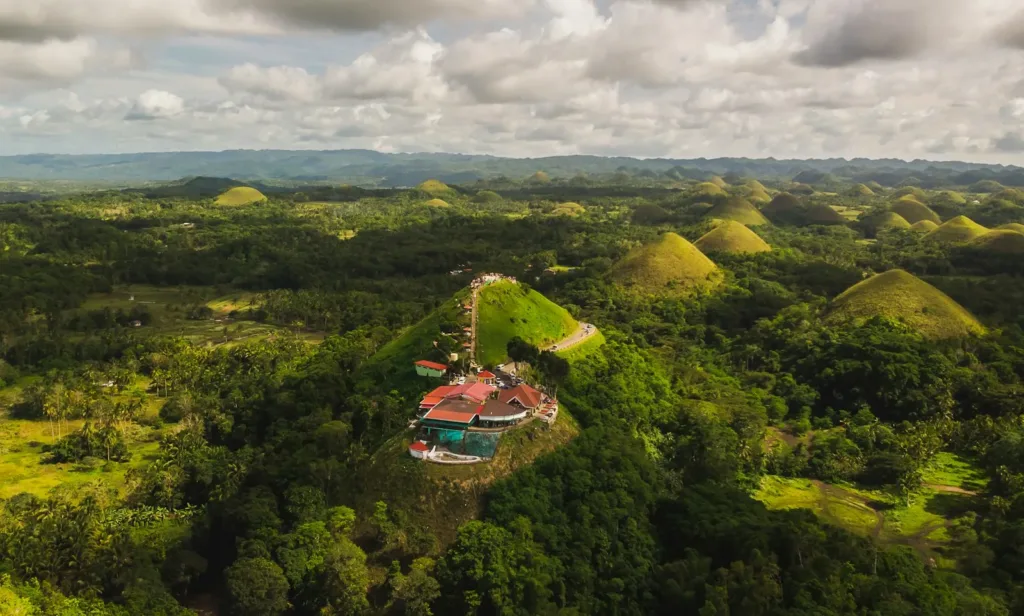 bohol travel guide aerial view of green trees under cloudy sky during daytime