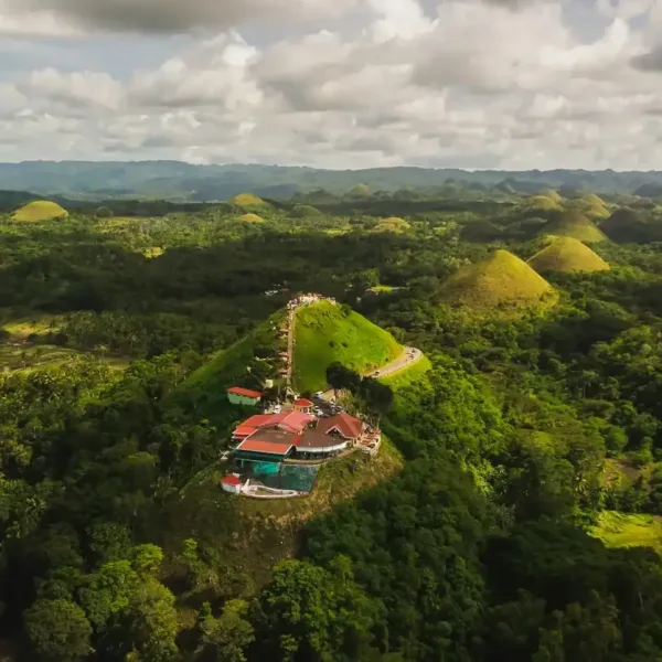 bohol travel guide aerial view of green trees under cloudy sky during daytime