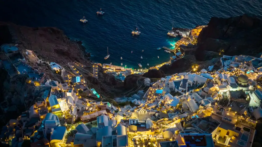 Santorini Travel Guide an aerial view of a city at night