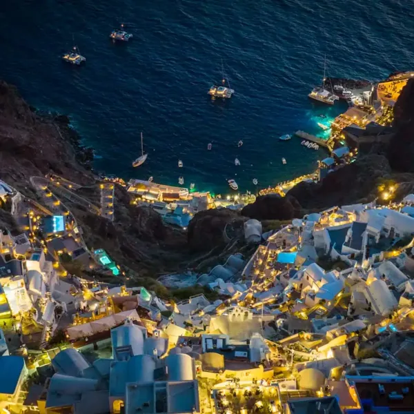 Santorini Travel Guide an aerial view of a city at night