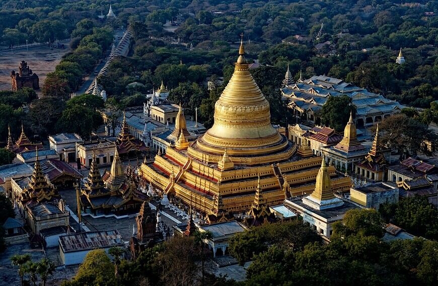 Myanmar Travel Guide brown and white concrete building near green trees during daytime