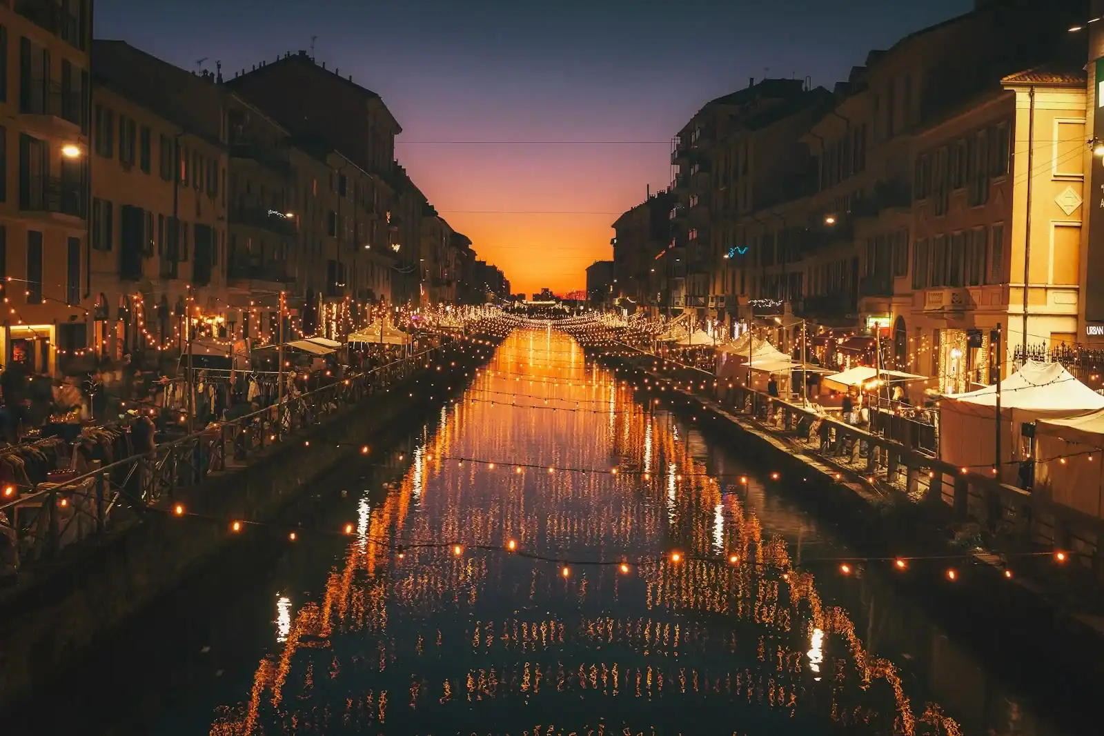 Milan Travel Guide reflective photography of string lights above river