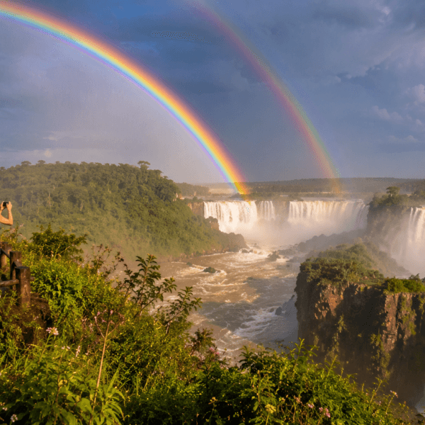 Double rainbow over majestic waterfall view