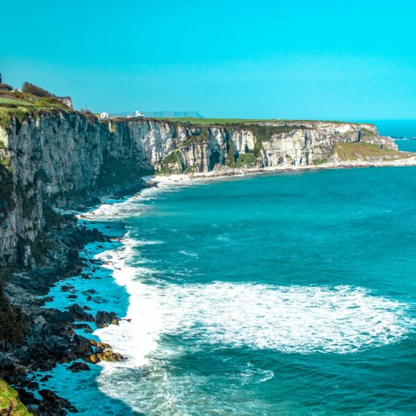 Visiting Ireland white rock cliff beside body of water'