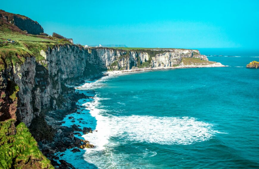 Visiting Ireland white rock cliff beside body of water'