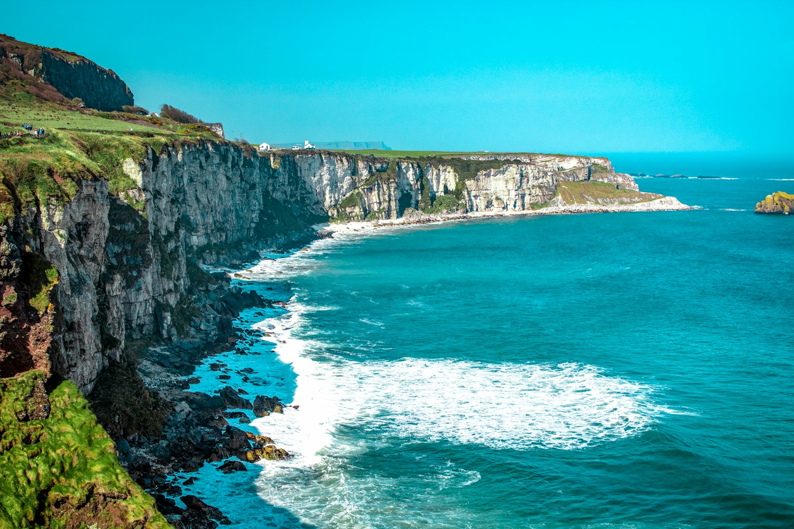 Visiting Ireland white rock cliff beside body of water'